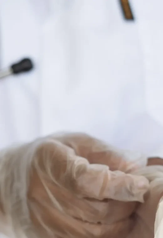 a zoomed in image of a healthcare worker wearing clothes and a white coat