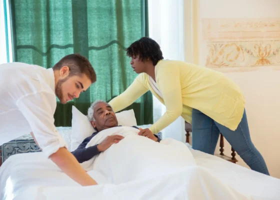 an image of two healthcare staff caring for a patient