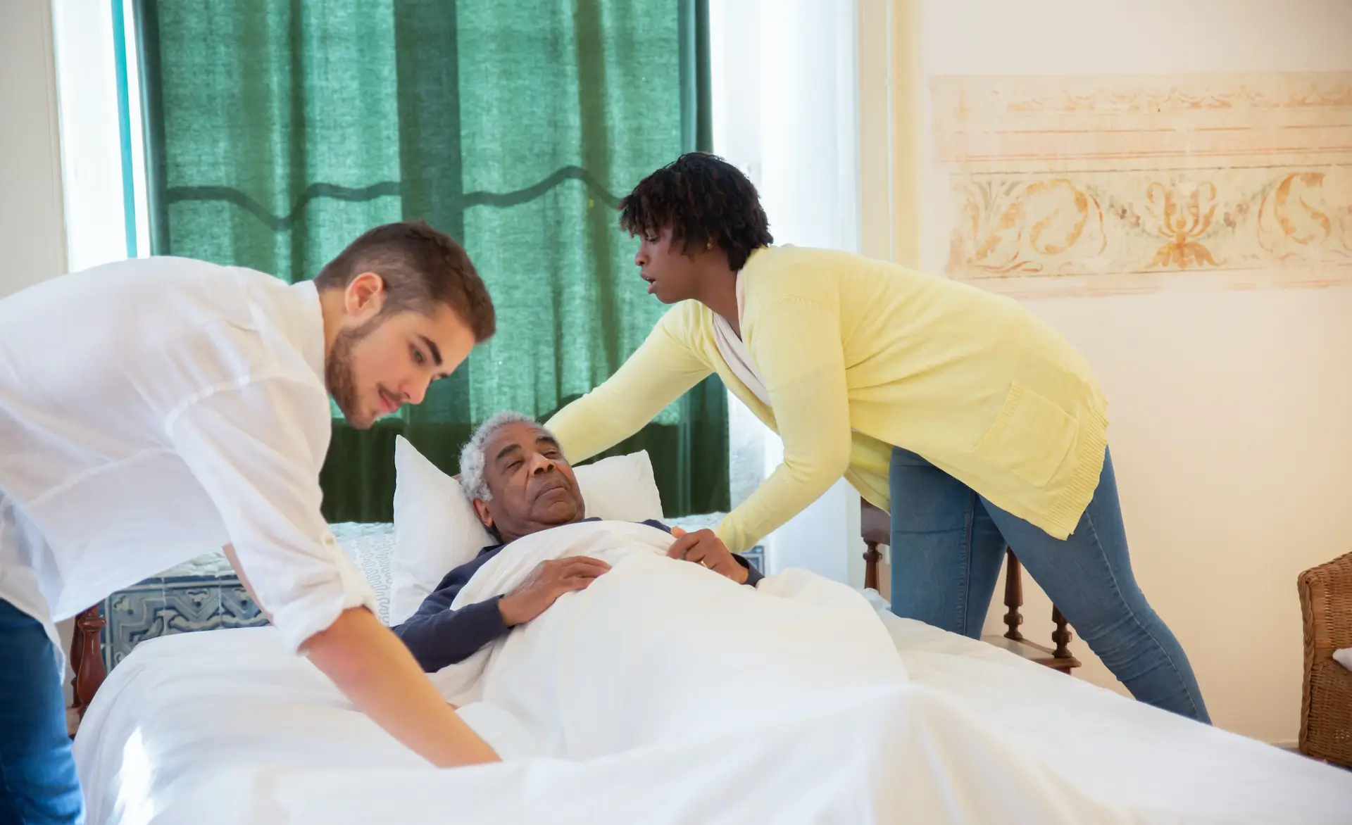 an image of two healthcare staff caring for a patient
