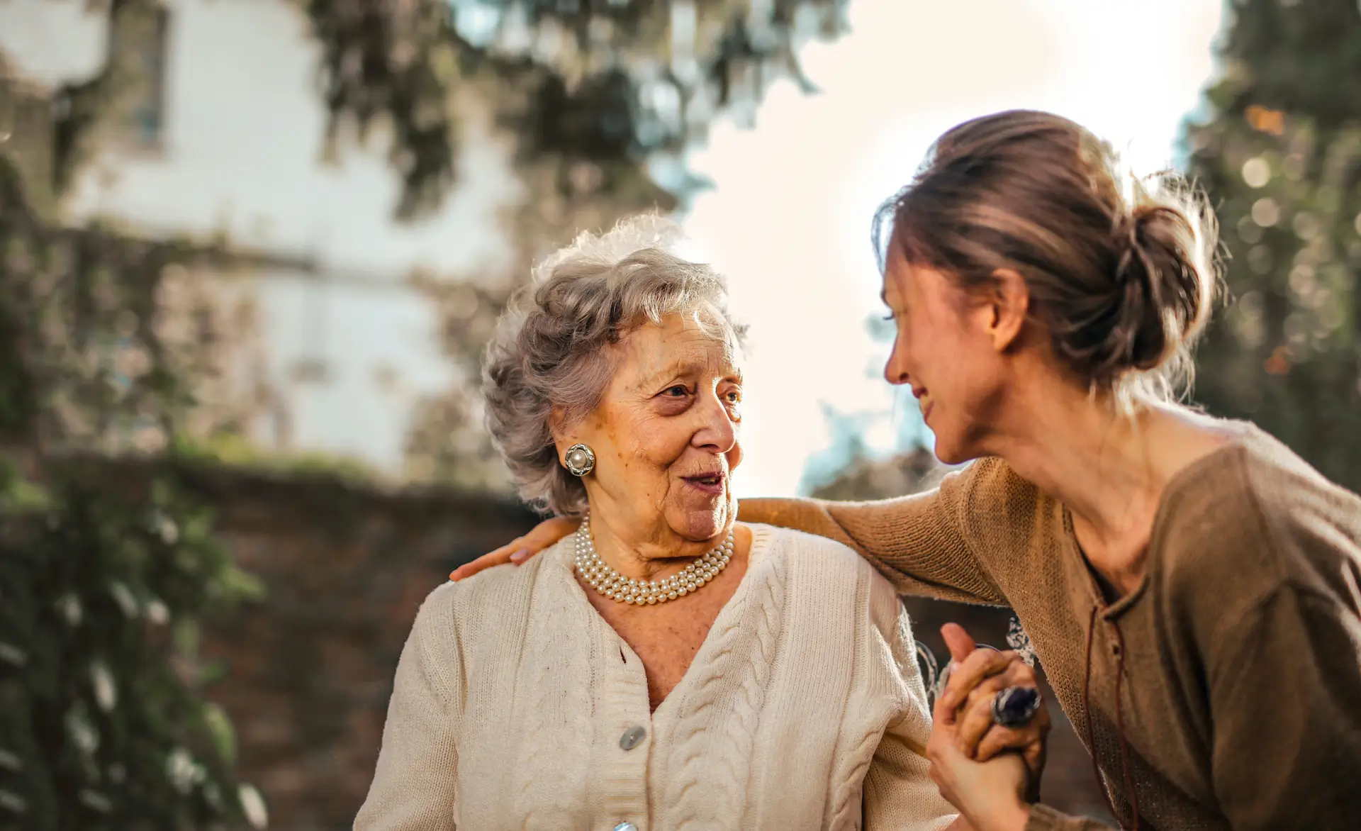 a care worker with her arm round a patient showing strong care worker skills