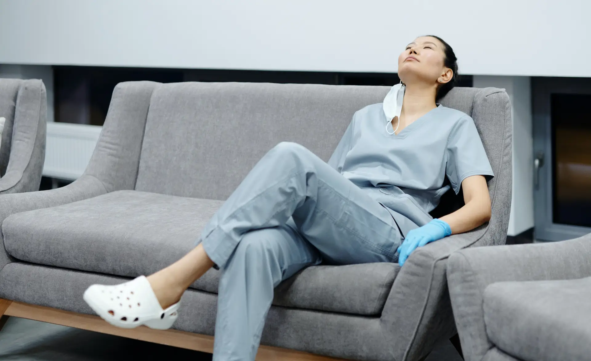 an image of a healthcare assistant sat on a couch