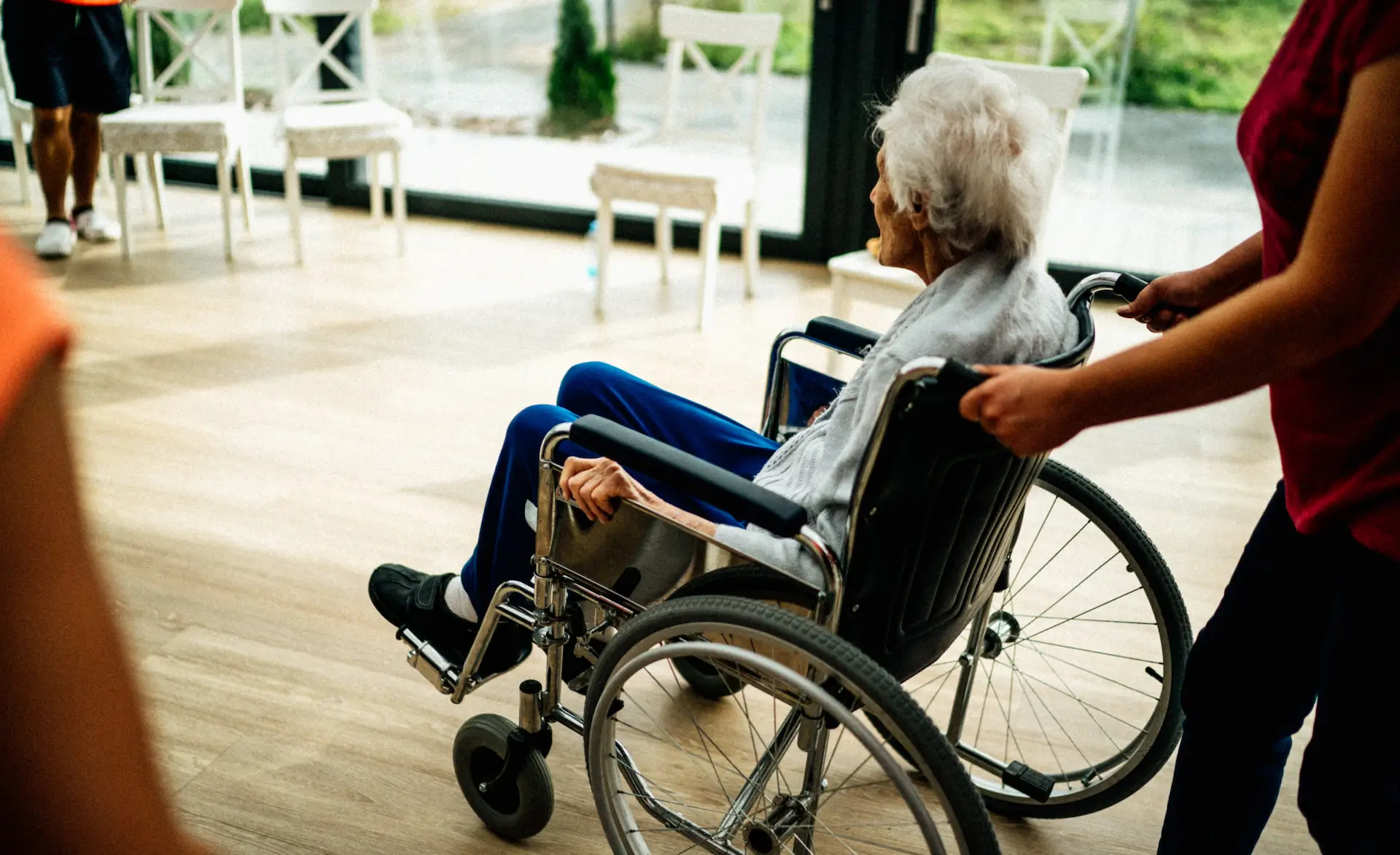 older lady being pushed in a wheelchair