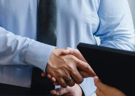 a zoomed in image of two people shaking hands