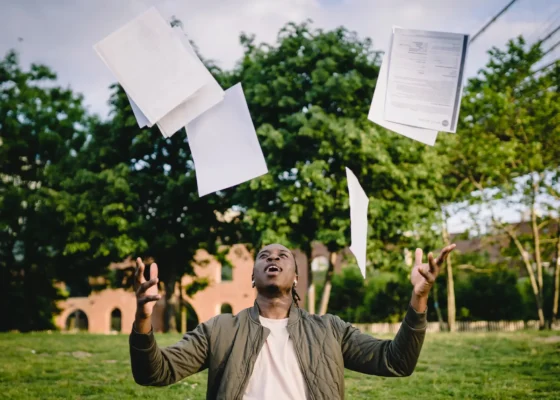 an image of someone throwing their documents in the air after a successful healthcare interview