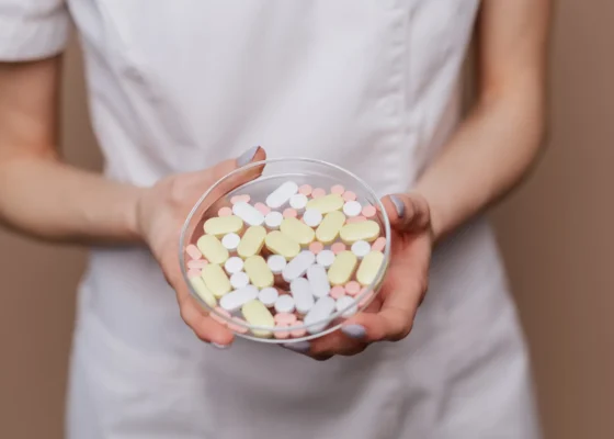 a healthcare assistant holding prescription pills