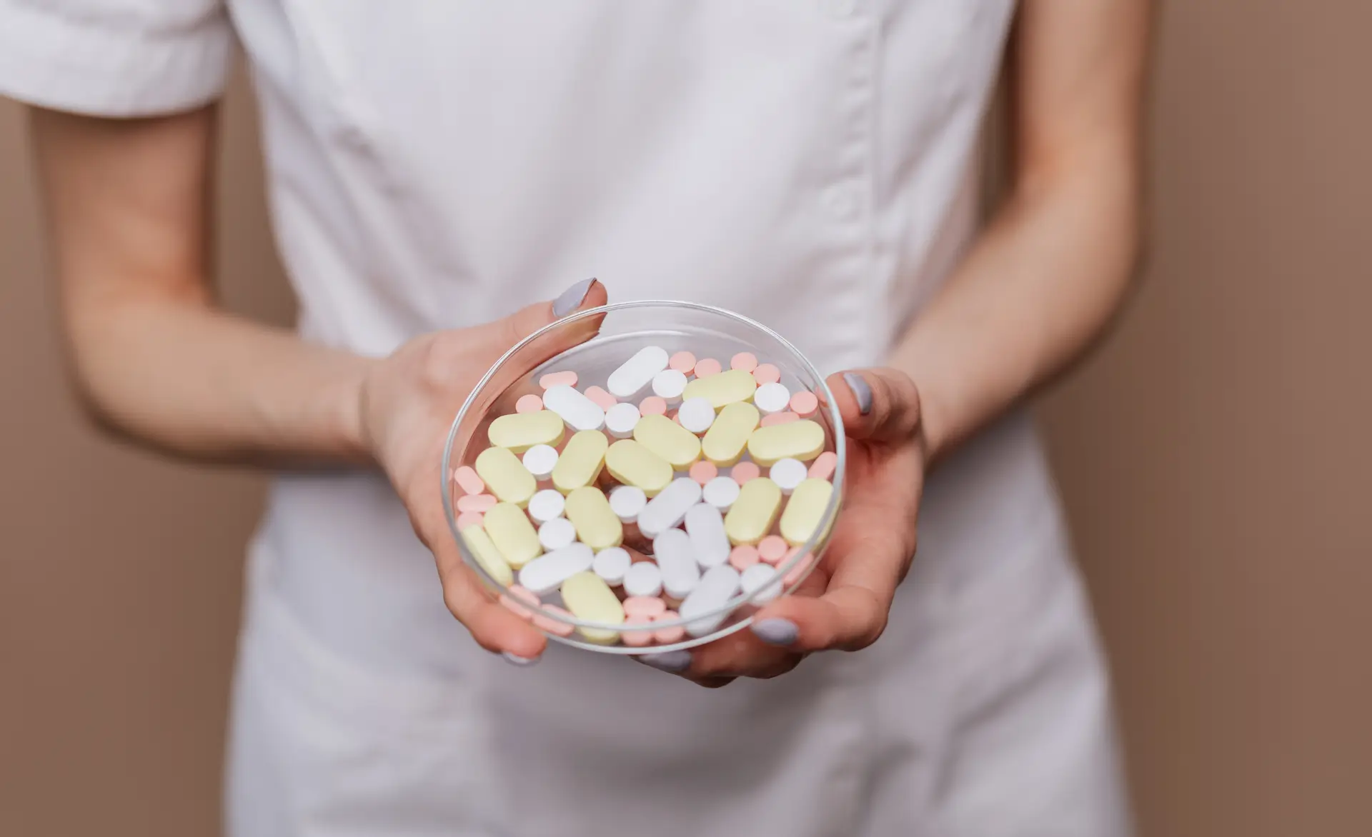 a healthcare assistant holding prescription pills