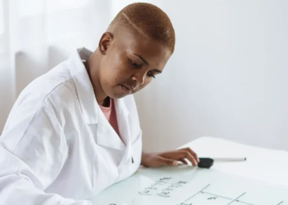 a healthcare professional writing on a whiteboard