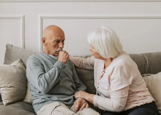 An older couple sat together talking intently