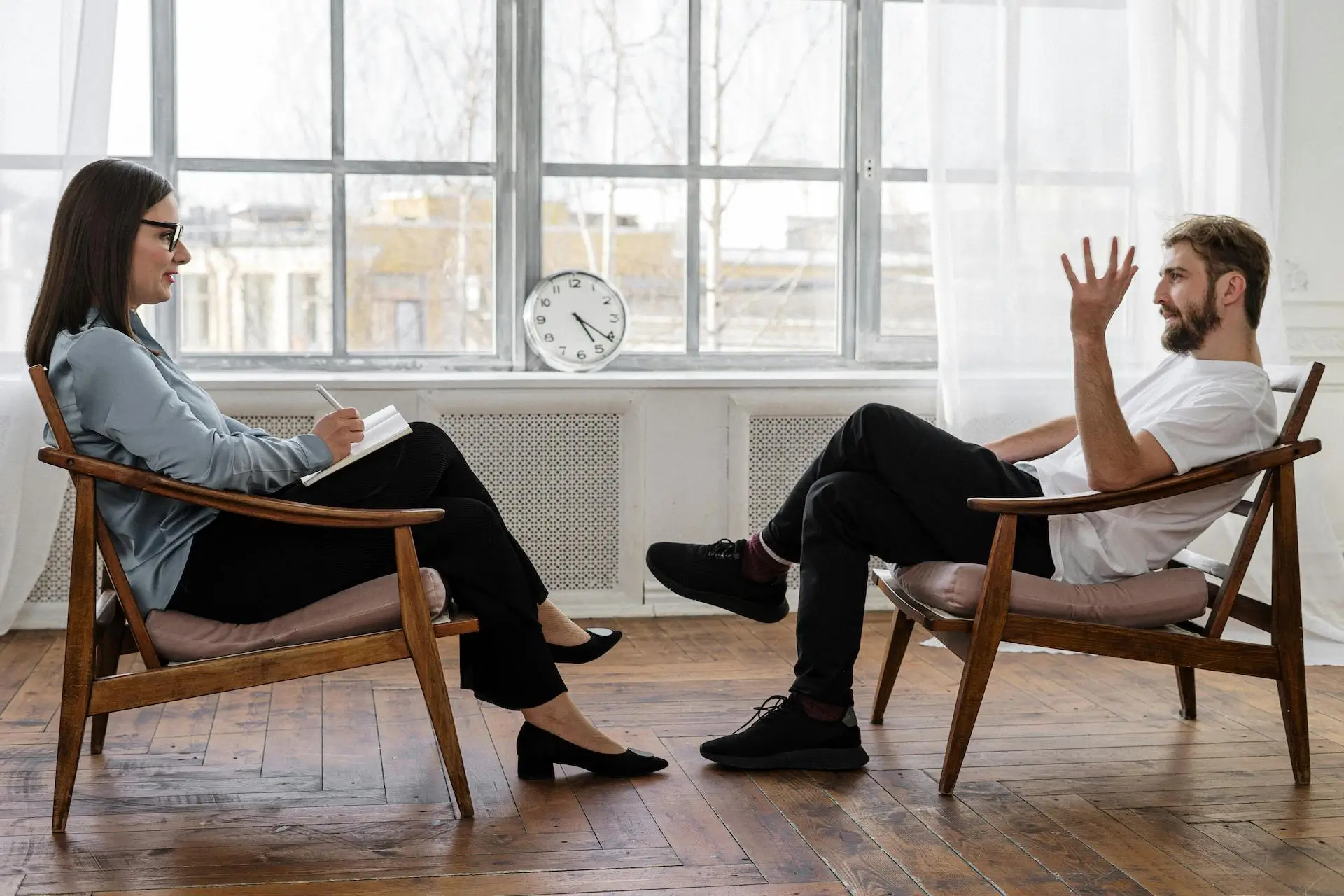 an image of a mental health support worker sat with a patient