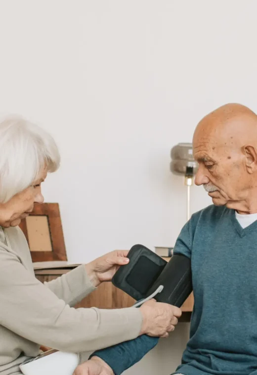 an image of an elderly woman checking the blood pressure of a man