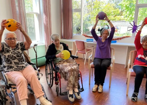 elderly people in wheelchairs playing with balls