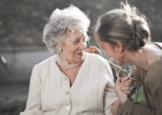 an image of a carer and a patient talking and smiling representing person-centred care