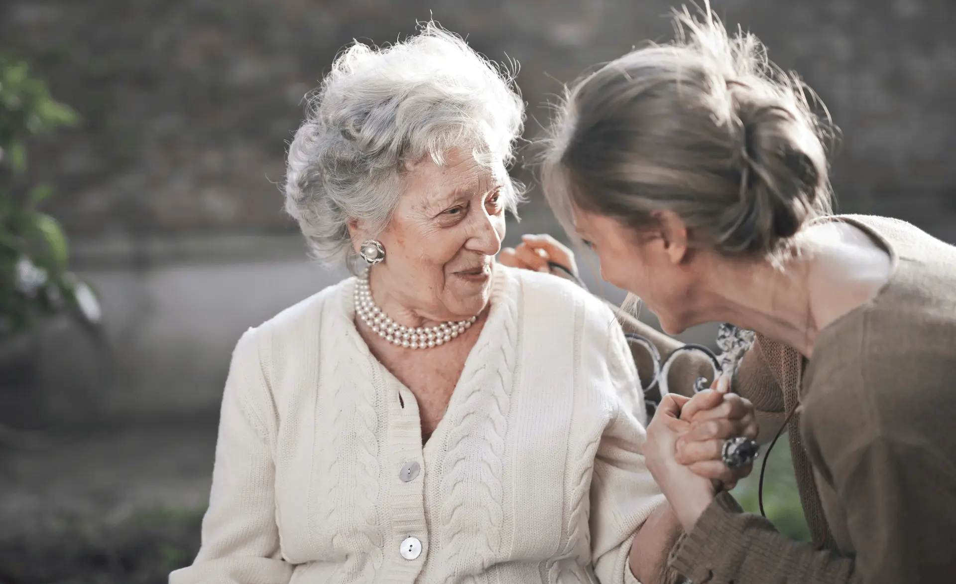 an image of a carer and a patient talking and smiling representing person-centred care