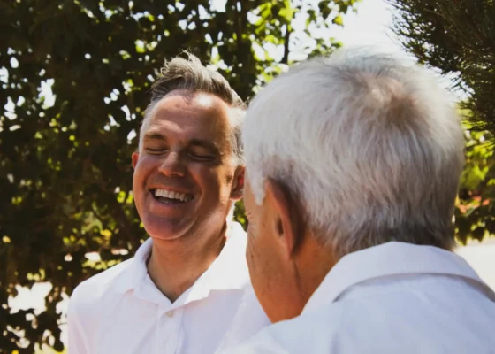 adult care provider with his father wondering how to offset the rising healthcare costs as a caregiver