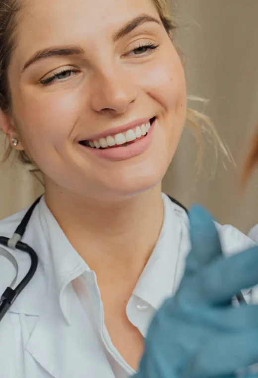 Image of a nurse examining a patient with a smile on her face