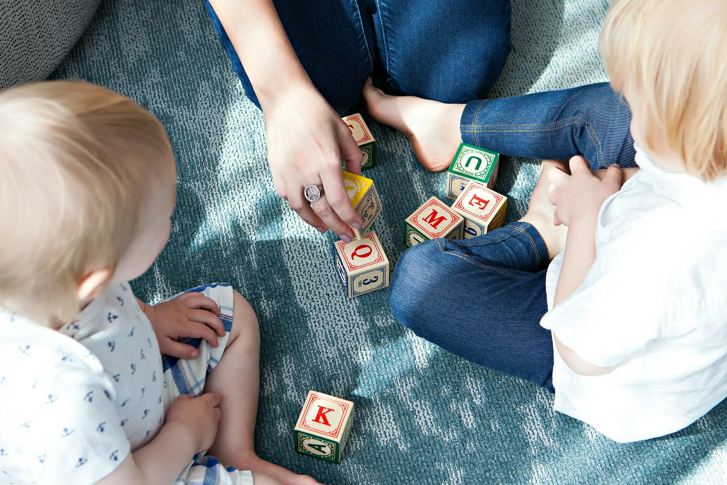 a childcare staffing agency recruit supporting children while playing