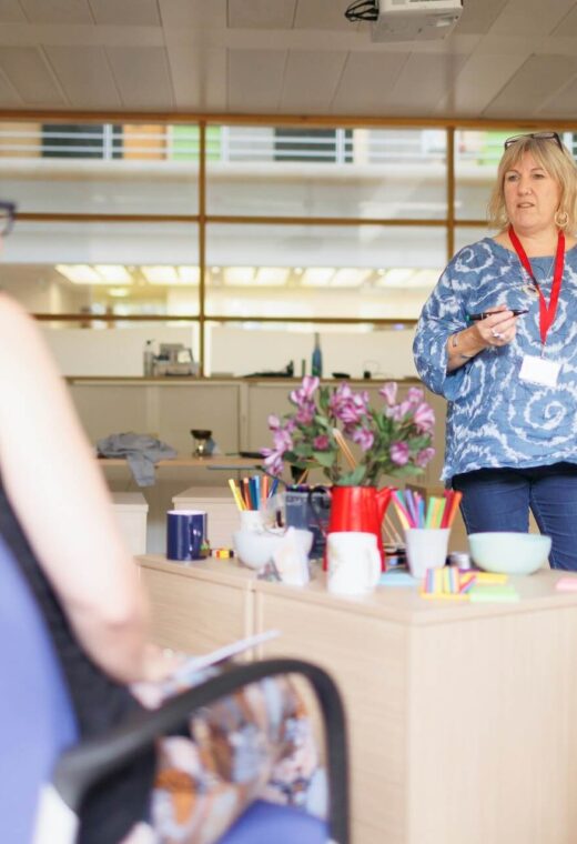 a woman teaching a group on restraint training for healthcare workers