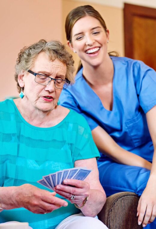 a nurse with a resident discussing what is the difference between nurse staffing and nurse recruitment