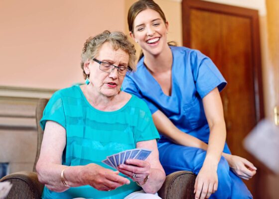 a nurse with a resident discussing what is the difference between nurse staffing and nurse recruitment